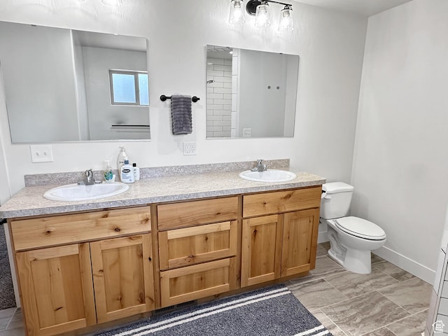 1005 S Valley View Ct, Moab, UT 84532 - bathroom featuring double vanity, toilet, and baseboards