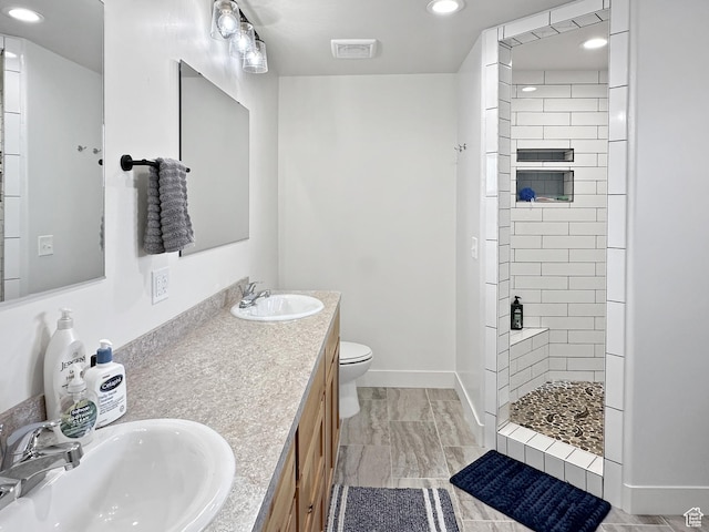 1005 S Valley View Ct, Moab, UT 84532 - full bath with a tile shower, double vanity, toilet, baseboards, and recessed lighting