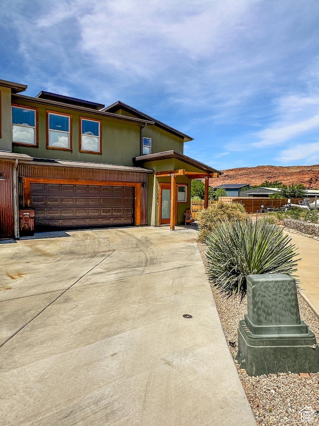 1005 S Valley View Ct, Moab, UT 84532 - view of front of property with an attached garage, concrete driveway, and stucco siding