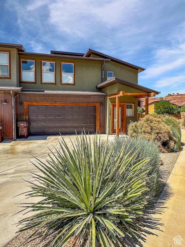 1005 S Valley View Ct, Moab, UT 84532 - view of front of house featuring a garage, stucco siding, and driveway
