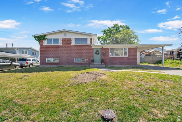 672 Nelson Ave, Tooele, UT 84074 - split level home with brick siding, a carport, a front lawn, and driveway