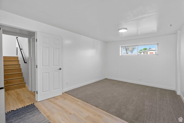 672 Nelson Ave, Tooele, UT 84074 - below grade area featuring stairs, baseboards, and wood finished floors