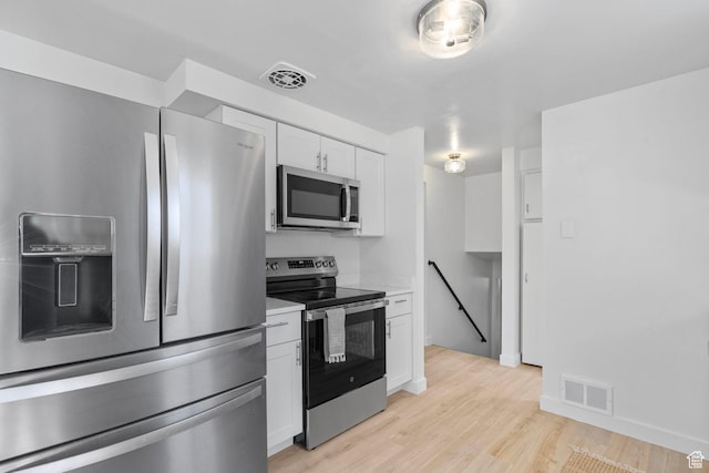 672 Nelson Ave, Tooele, UT 84074 - kitchen featuring stainless steel appliances, white cabinets, light countertops, light wood-style floors, and baseboards