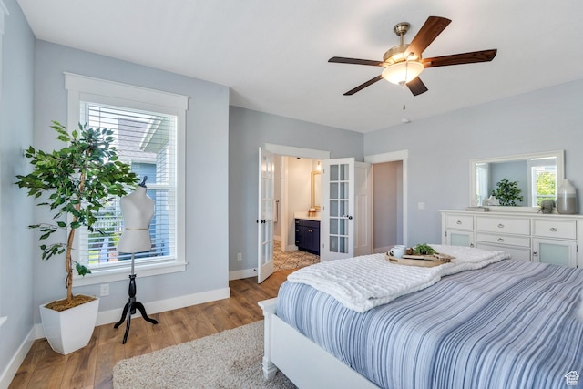11221 S Prosperity Rd, South Jordan, UT 84009 - bedroom featuring wood finished floors, french doors, baseboards, ensuite bath, and a ceiling fan