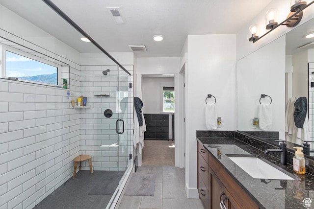 325 W 3170 S, Nibley, UT 84321 - bathroom featuring vanity, a shower stall, and tile walls