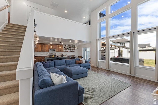 325 W 3170 S, Nibley, UT 84321 - living area featuring stairway, healthy amount of natural light, wood finished floors, recessed lighting, and a high ceiling