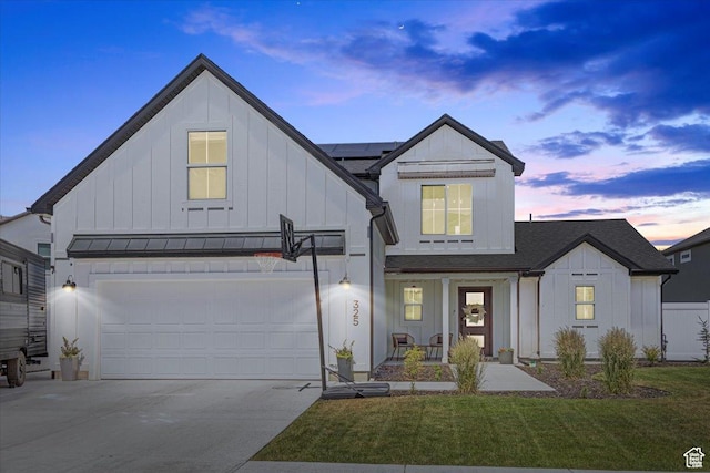325 W 3170 S, Nibley, UT 84321 - modern farmhouse style home with board and batten siding, driveway, covered porch, a yard, and roof mounted solar panels