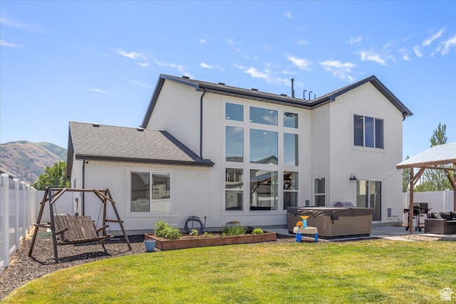 325 W 3170 S, Nibley, UT 84321 - back of property featuring a hot tub, stucco siding, a patio area, a mountain view, and a gazebo
