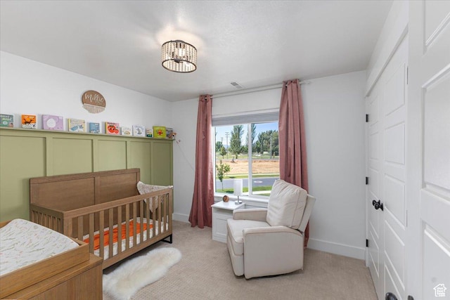 325 W 3170 S, Nibley, UT 84321 - bedroom with light colored carpet, a crib, a chandelier, and baseboards