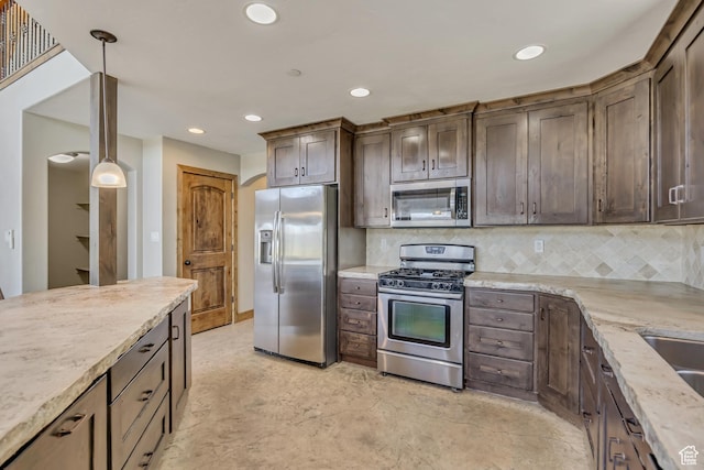1675 S Beaver Bench Rd E Unit 1417, Heber City, UT 84032 - kitchen featuring appliances with stainless steel finishes, recessed lighting, dark brown cabinetry, backsplash, and light stone counters