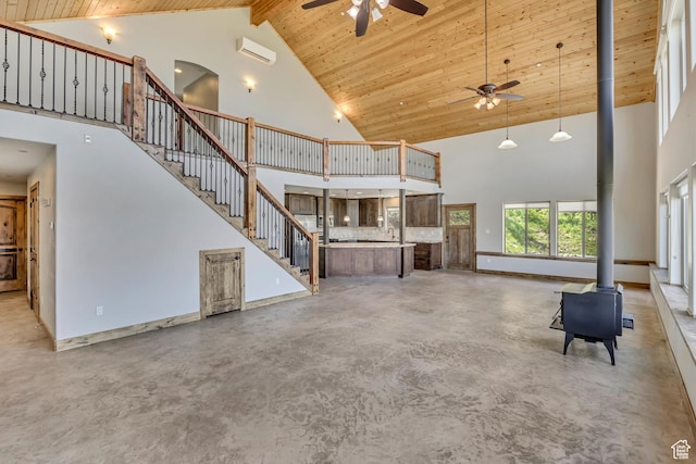 1675 S Beaver Bench Rd E Unit 1417, Heber City, UT 84032 - unfurnished living room with a wood stove, high vaulted ceiling, a ceiling fan, stairs, and finished concrete flooring