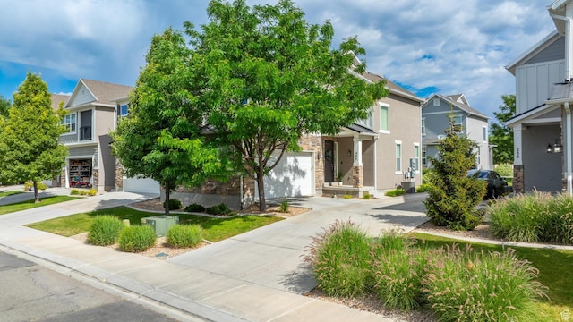 244 E Cordoba Dr, Saratoga Springs, UT 84045 - obstructed view of property featuring concrete driveway, a residential view, stone siding, stucco siding, and an attached garage