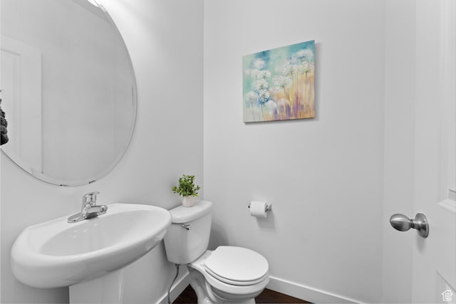 244 E Cordoba Dr, Saratoga Springs, UT 84045 - half bathroom featuring toilet, baseboards, and a sink
