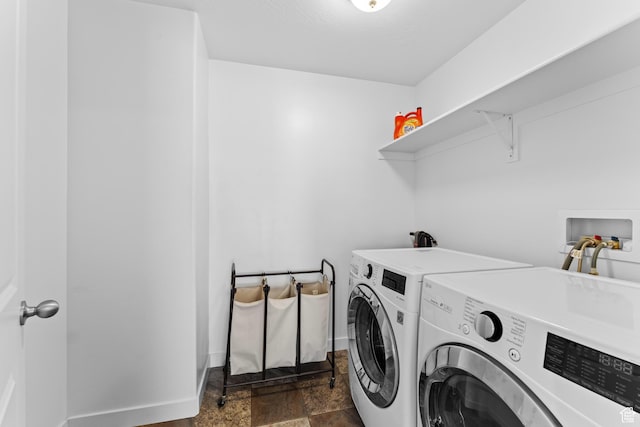 244 E Cordoba Dr, Saratoga Springs, UT 84045 - laundry room featuring washer and clothes dryer, dark stone finish floors, and baseboards