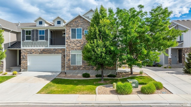 244 E Cordoba Dr, Saratoga Springs, UT 84045 - craftsman-style home with stone siding, driveway, board and batten siding, a garage, and a front yard