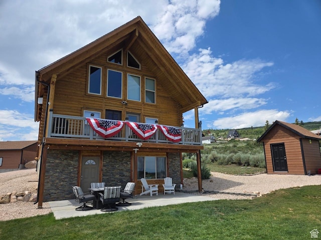 3500 S Sweetwater Pkwy Unit 4, Garden City, UT 84028 - rear view of house featuring a patio, a yard, and stone siding