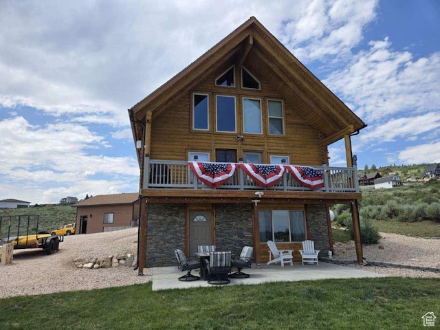 3500 S Sweetwater Pkwy Unit 4, Garden City, UT 84028 - back of property with a patio, stone siding, a lawn, and a deck