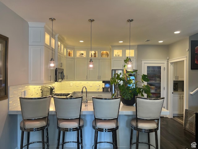 3256 W Harvest Chase Dr, South Jordan, UT 84095 - kitchen featuring a peninsula, black microwave, glass insert cabinets, white cabinets, and decorative backsplash
