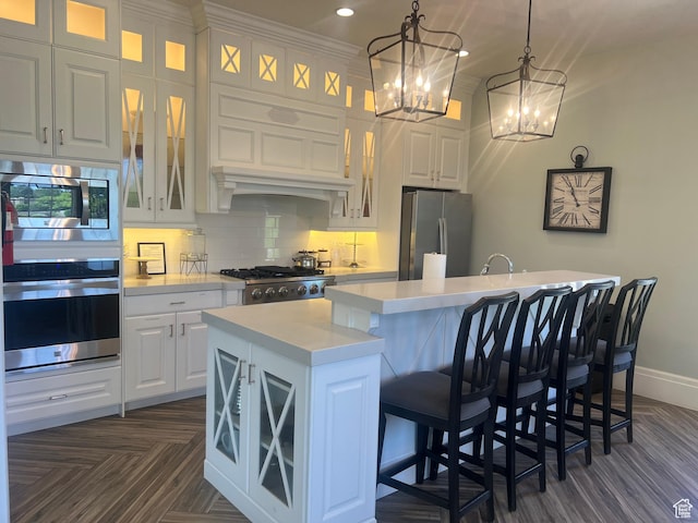 3256 W Harvest Chase Dr, South Jordan, UT 84095 - kitchen with appliances with stainless steel finishes, a kitchen island with sink, light countertops, white cabinets, and recessed lighting