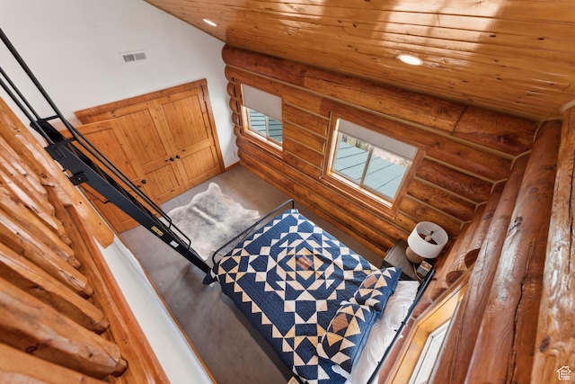 1085 Moose Hollow Rd, Robertson, WY 82944 - interior space featuring log walls, wooden ceiling, carpet, and recessed lighting