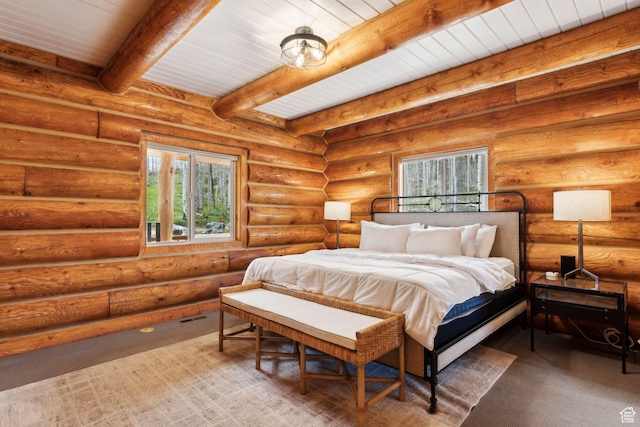 1085 Moose Hollow Rd, Robertson, WY 82944 - carpeted bedroom featuring multiple windows and wooden ceiling with exposed beams