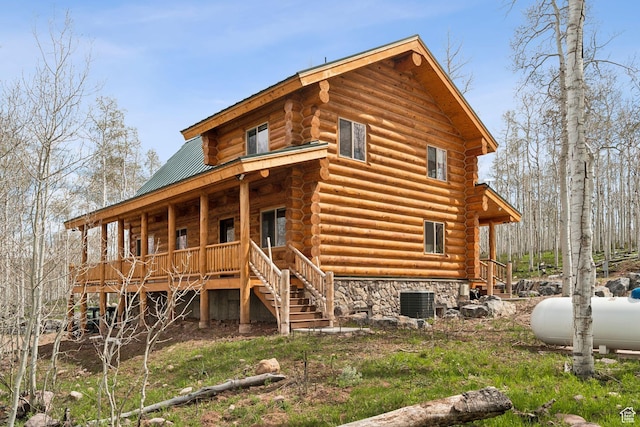 1085 Moose Hollow Rd, Robertson, WY 82944 - back of house with log exterior, covered porch, stairs, and metal roof