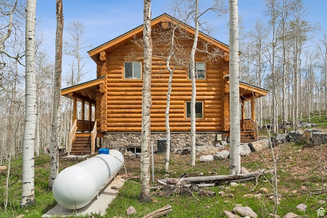 1085 Moose Hollow Rd, Robertson, WY 82944 - view of home's exterior featuring log exterior and stone siding