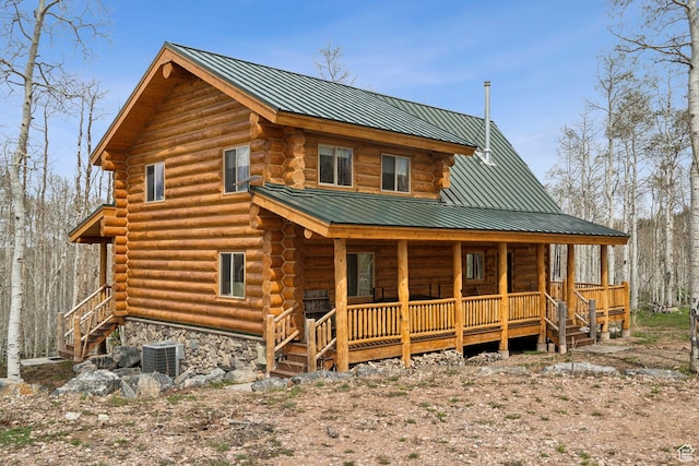 1085 Moose Hollow Rd, Robertson, WY 82944 - back of property with log exterior, covered porch, central AC unit, metal roof, and stairway