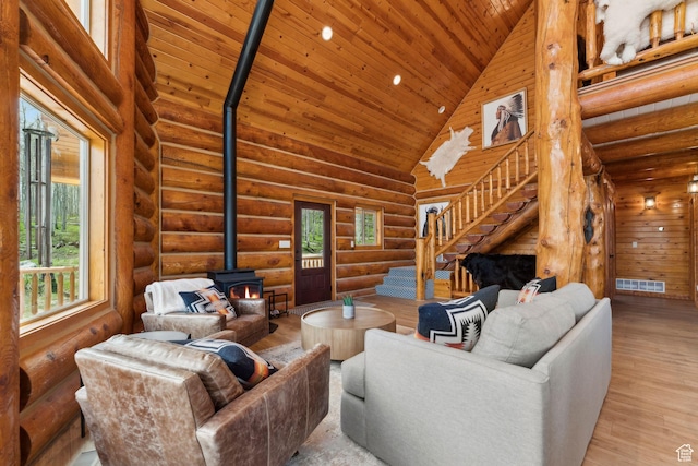 1085 Moose Hollow Rd, Robertson, WY 82944 - living area featuring a wood stove, high vaulted ceiling, stairway, wooden ceiling, and wood finished floors