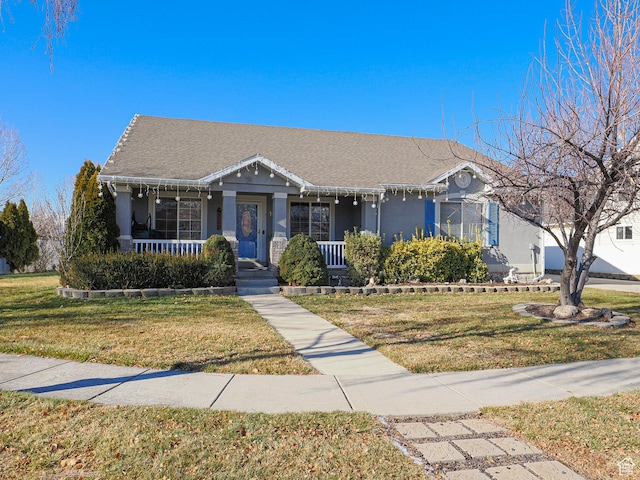 1875 N 270 W, Tooele, UT 84074 - view of front facade featuring a porch, stucco siding, and a front yard
