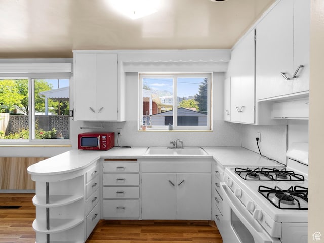 1026 N 500 E, Logan, UT 84341 - kitchen featuring white range with gas stovetop, a sink, open shelves, and healthy amount of natural light