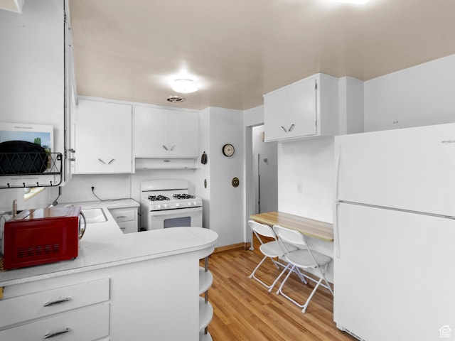 1026 N 500 E, Logan, UT 84341 - kitchen with white appliances, under cabinet range hood, light countertops, light wood-style floors, and white cabinets