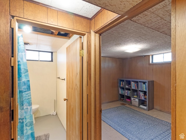 1026 N 500 E, Logan, UT 84341 - bathroom featuring wood walls, toilet, plenty of natural light, and a shower with curtain