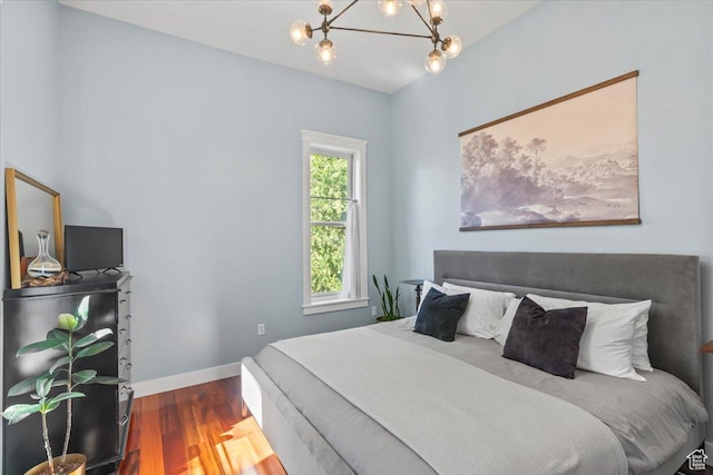 479 N Main St, Farmington, UT 84025 - bedroom featuring a chandelier, wood finished floors, and baseboards