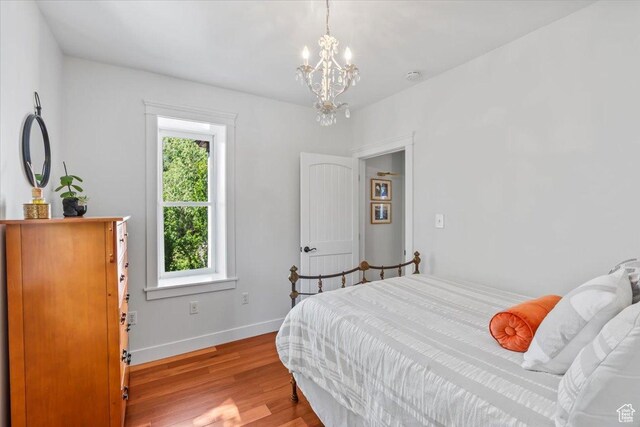 479 N Main St, Farmington, UT 84025 - bedroom featuring multiple windows, wood finished floors, a chandelier, and baseboards