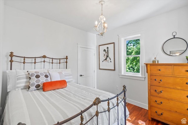 479 N Main St, Farmington, UT 84025 - bedroom featuring wood finished floors, a chandelier, and baseboards