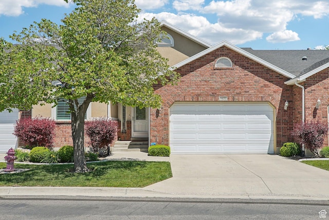 9451 S Peaceful View Way S, Jordan, UT 84095 - view of front facade featuring driveway, a garage, stucco siding, brick siding, and a front yard