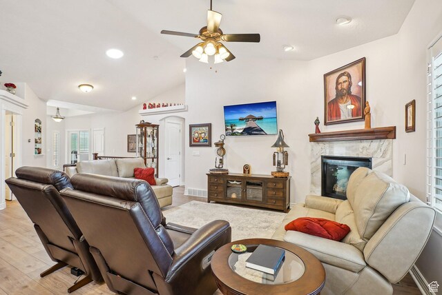 9451 S Peaceful View Way S, Jordan, UT 84095 - living area featuring a premium fireplace, ceiling fan, light wood-style flooring, plenty of natural light, and lofted ceiling