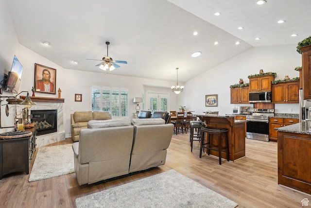 9451 S Peaceful View Way S, Jordan, UT 84095 - living room with ceiling fan, a premium fireplace, light wood-style flooring, recessed lighting, and a chandelier