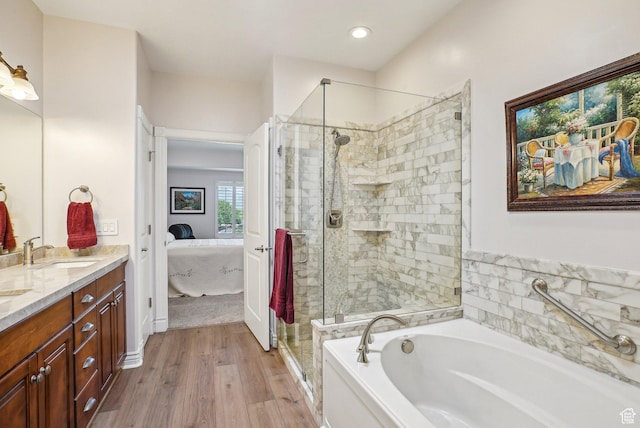 9451 S Peaceful View Way S, Jordan, UT 84095 - bathroom with connected bathroom, a bath, double vanity, a stall shower, and wood finished floors