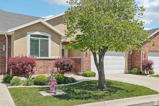 9451 S Peaceful View Way S, Jordan, UT 84095 - view of front facade with an attached garage, driveway, a front yard, brick siding, and stucco siding