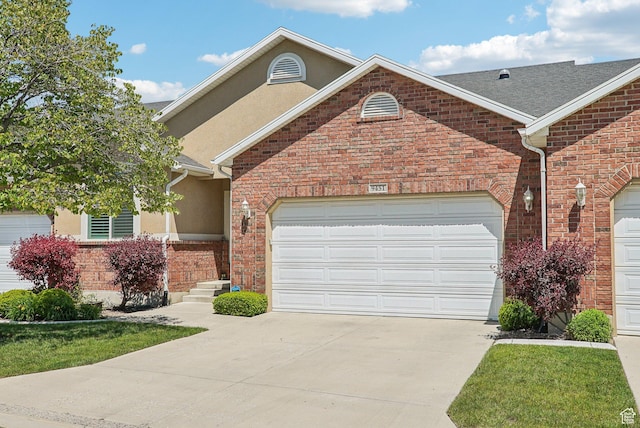 9451 S Peaceful View Way S, Jordan, UT 84095 - view of front facade featuring driveway, an attached garage, stucco siding, and brick siding