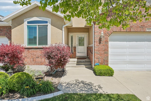 9451 S Peaceful View Way S, Jordan, UT 84095 - entrance to property with a garage, stucco siding, and brick siding