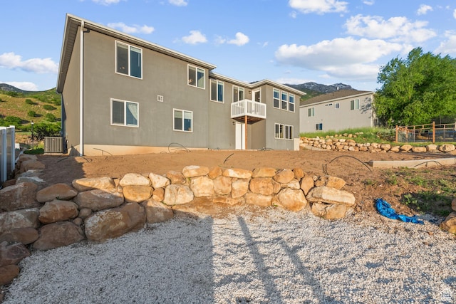 104 S 1250 E, Santaquin, UT 84655 - back of house with central air condition unit, a mountain view, stucco siding, a balcony, and a patio