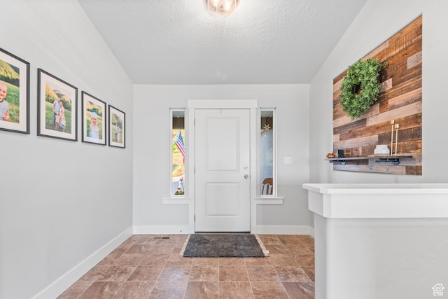104 S 1250 E, Santaquin, UT 84655 - foyer entrance with baseboards, a textured ceiling, and stone finish floors