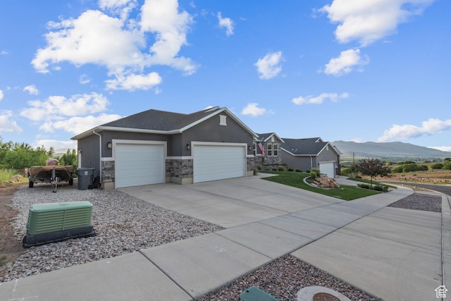 104 S 1250 E, Santaquin, UT 84655 - view of side of property with a garage, stone siding, stucco siding, concrete driveway, and a mountain view