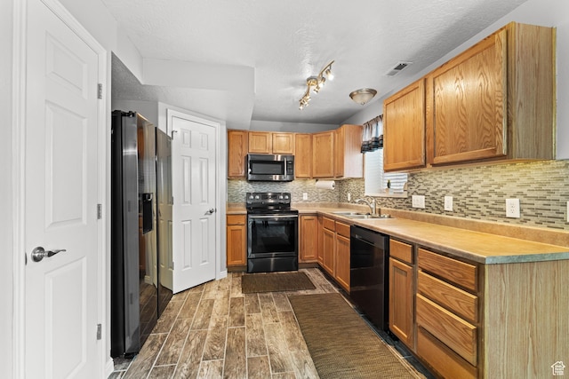 2384 N Nectar Way E, Saratoga Springs, UT 84045 - kitchen featuring black appliances, a sink, backsplash, wood finished floors, and light countertops