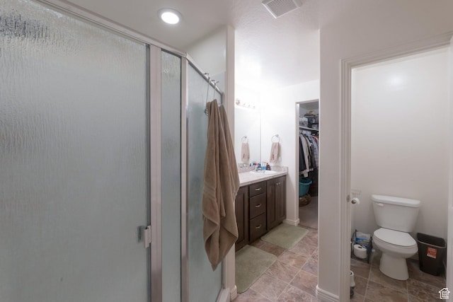 491 Travertine Way, Santaquin, UT 84655 - full bathroom with a shower stall, toilet, a walk in closet, vanity, and tile patterned flooring