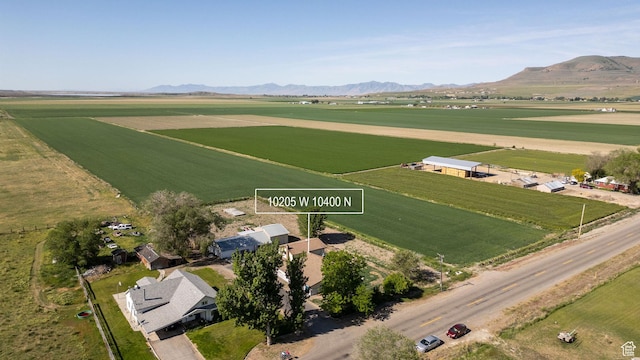 10205 W 10400 N, Tremonton, UT 84337 - aerial overview of property's location with rural landscape, rows of crops, and a mountainous background