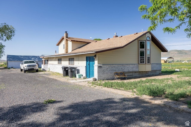 10205 W 10400 N, Tremonton, UT 84337 - view of property exterior featuring a chimney and brick siding